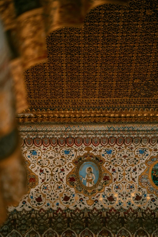 a large ornately designed, gilded ceiling with an elegant design