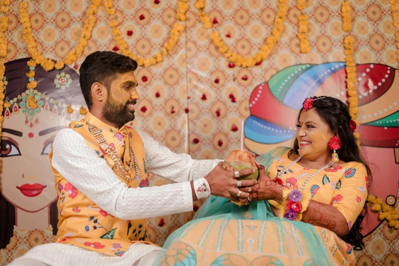 a man that is sitting down and holding onto a women's hand