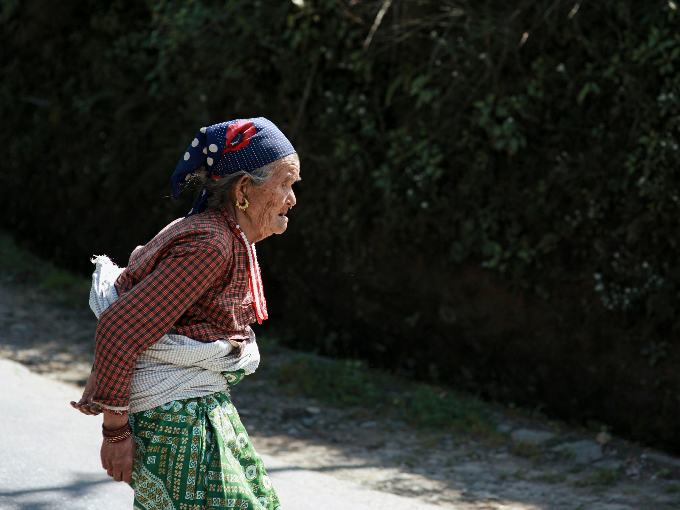 a woman walks down a street holding onto her purse