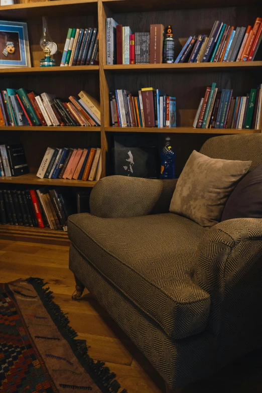 a large brown couch with many books on it