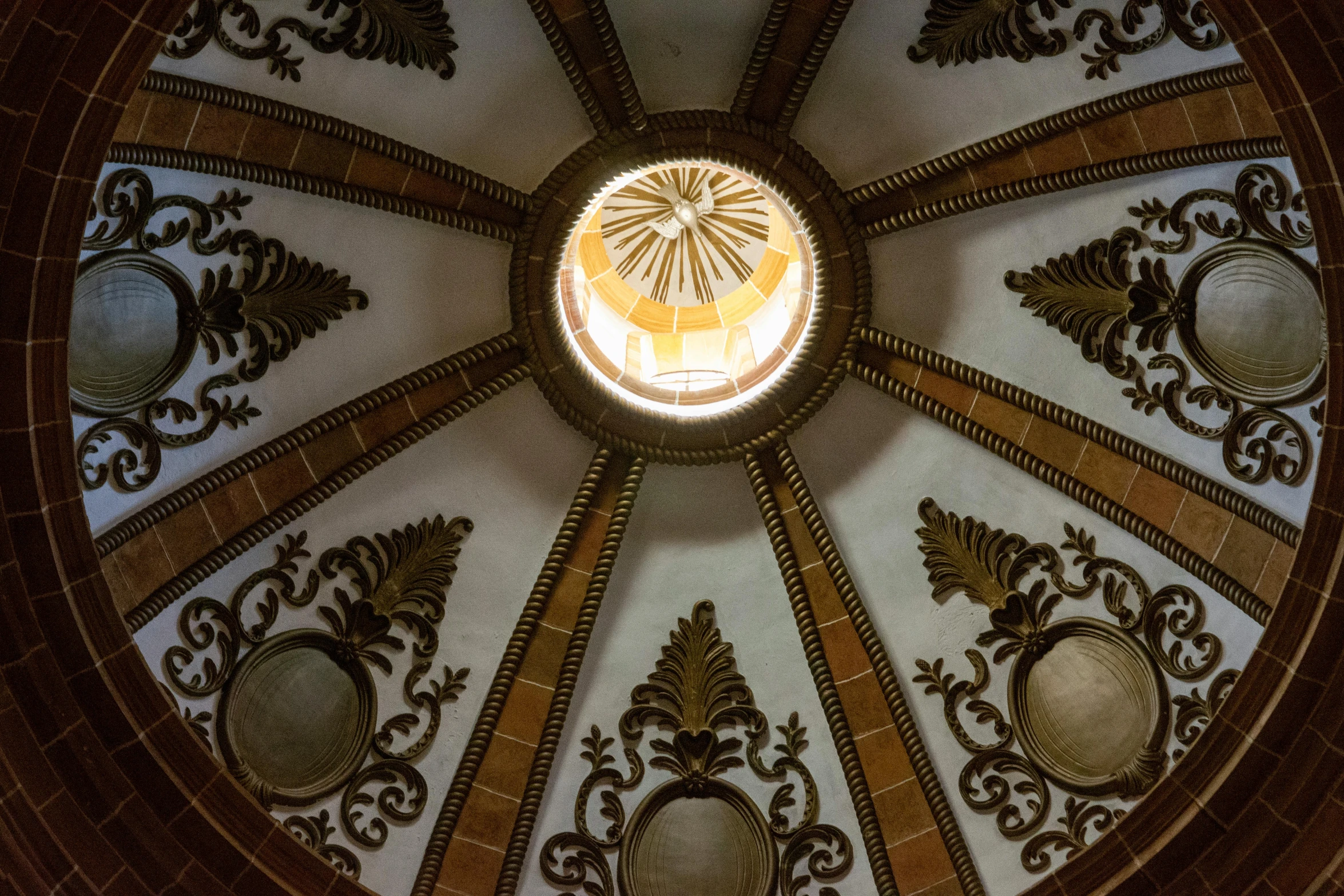 a domed ceiling with an ornate pattern with gold