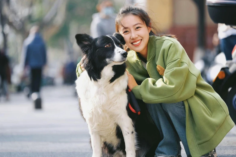 a woman petting a dog with people on the sidelines