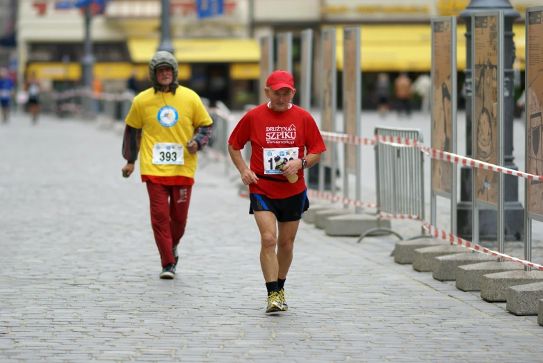 two men run on the street during the marathon