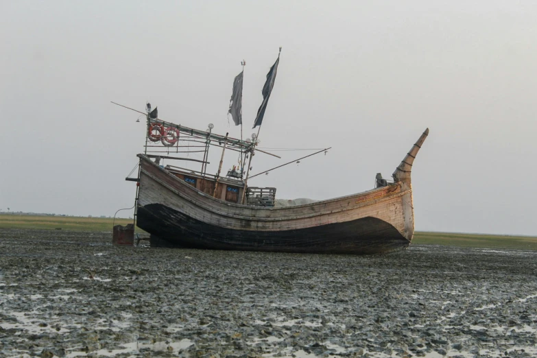 an old, wooden boat sitting on dry land