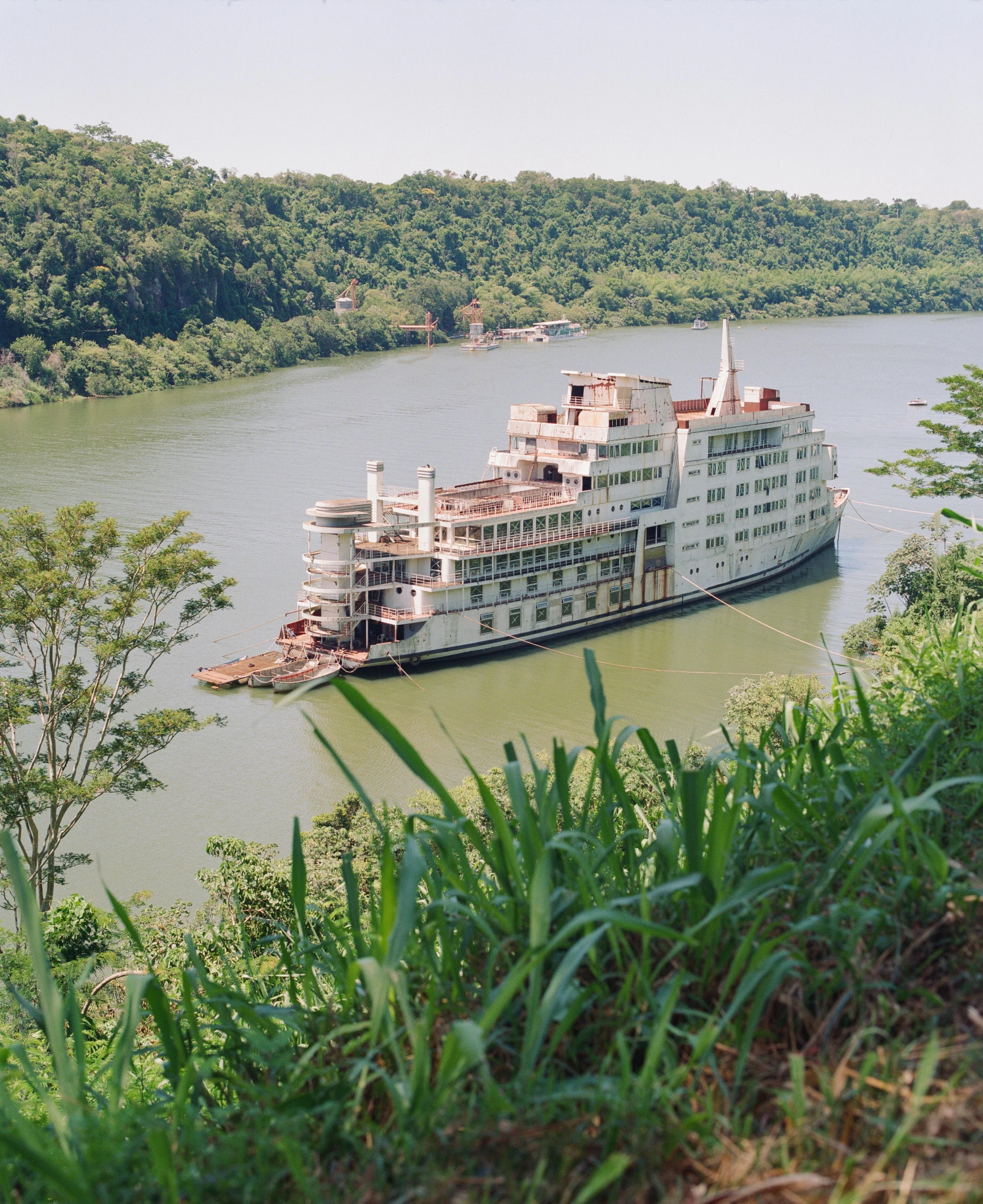 a ferry boat sailing on a river in the woods