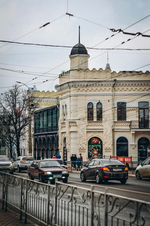 the car is traveling on the busy street