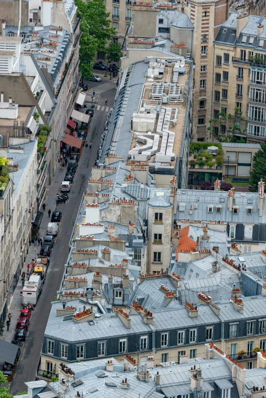 a city street in an aerial view with cars parked along the street