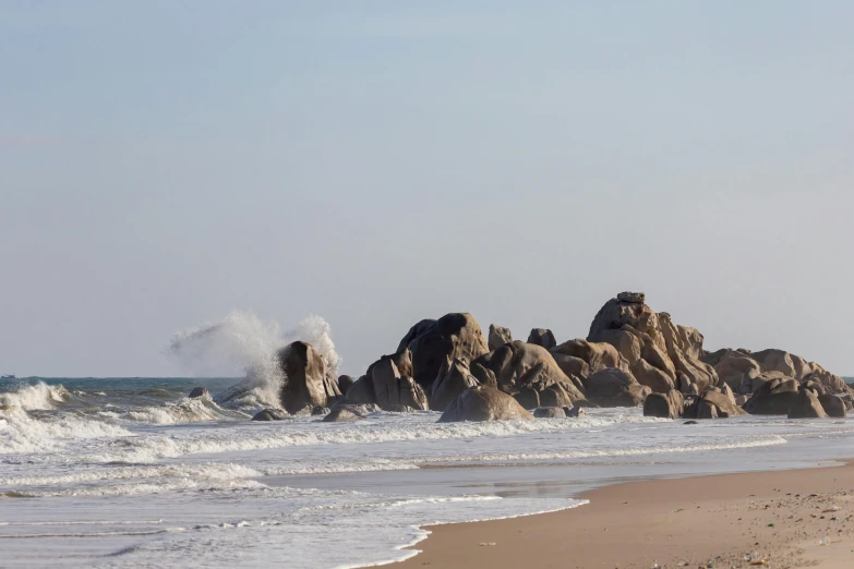 a person flying a kite on a beach with waves