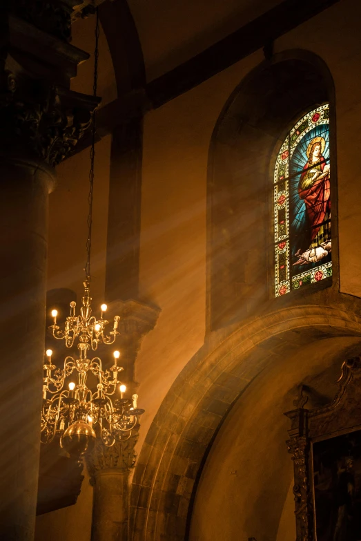 sunlight streaming through stained glass windows in a church