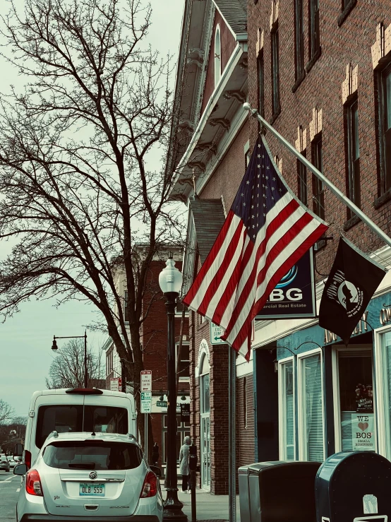 a street scene looking at many vehicles parked on the side of the road