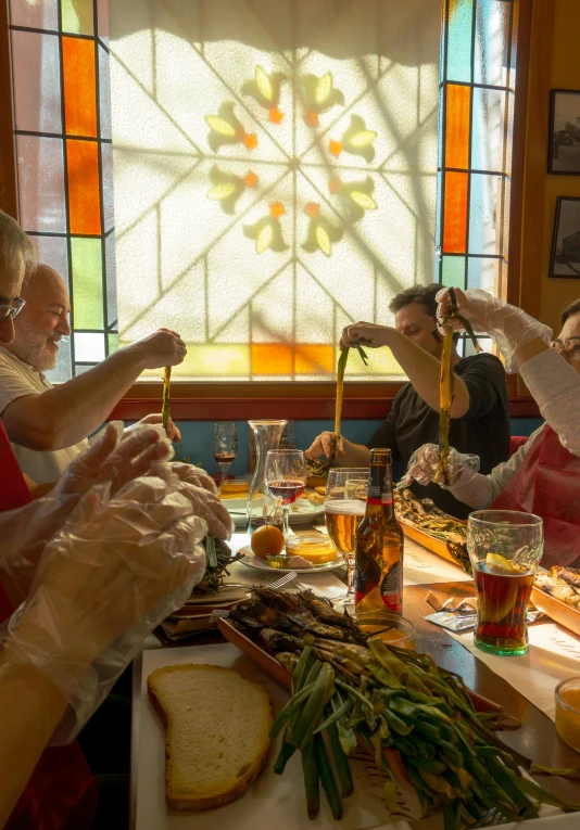 the group is sitting around a table preparing food