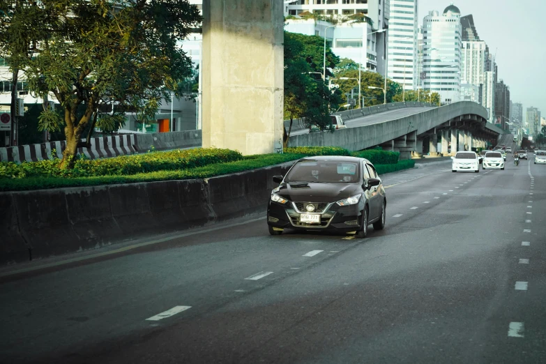 cars are driving in the traffic on a city street