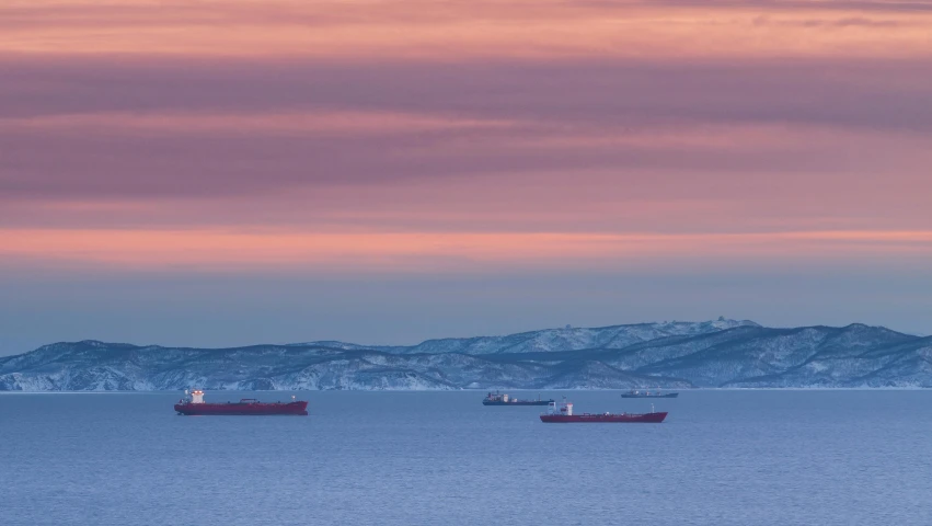 cargo ship with a larger cargo vessel on the far side of the ocean