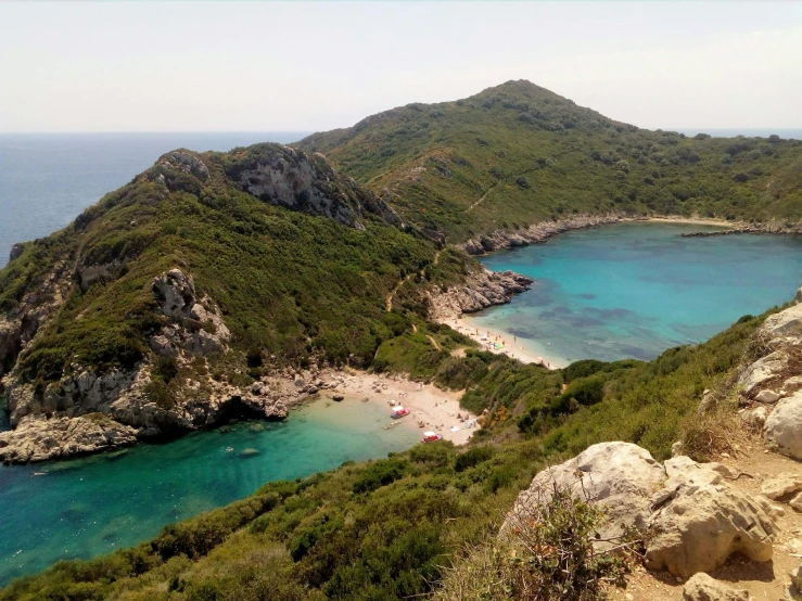 a small mountain range sitting over a beach