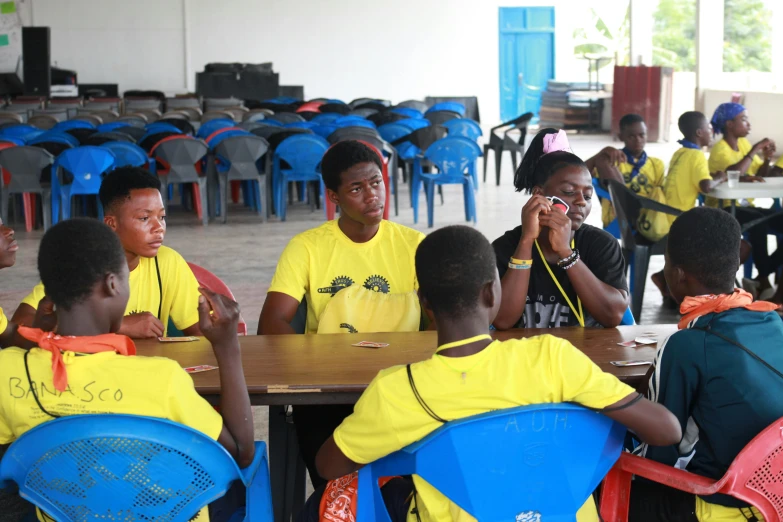 a group of s sitting at a table and talking