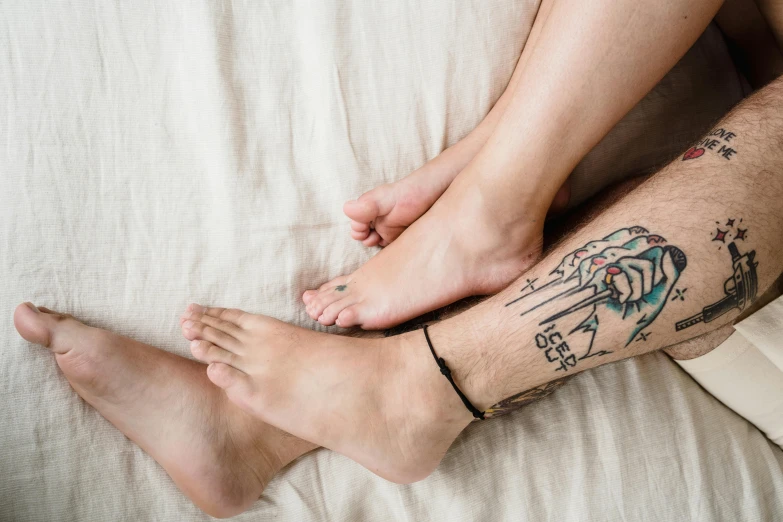 a person with a tattoo on their leg laying down