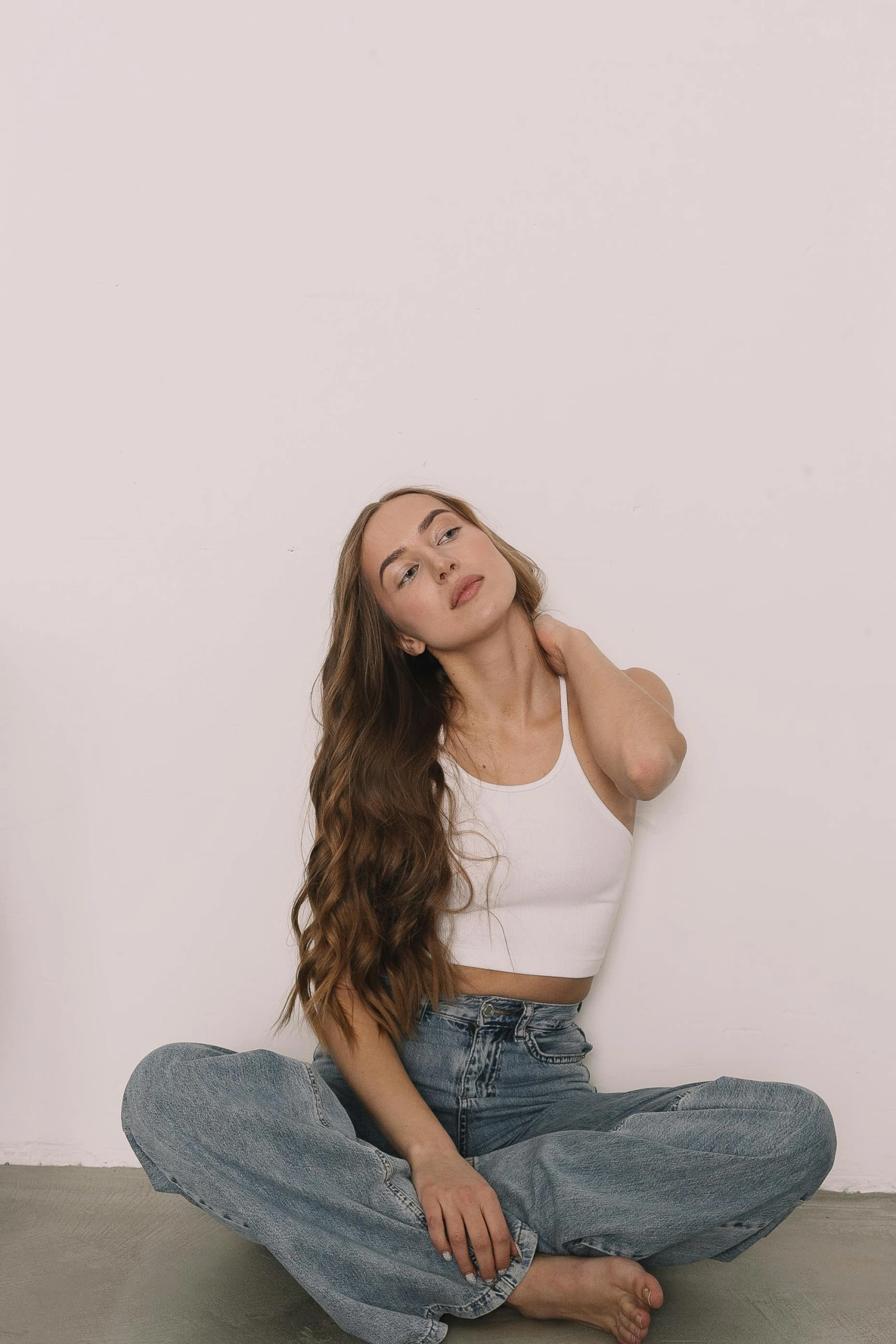 a woman is sitting in the floor with her long hair