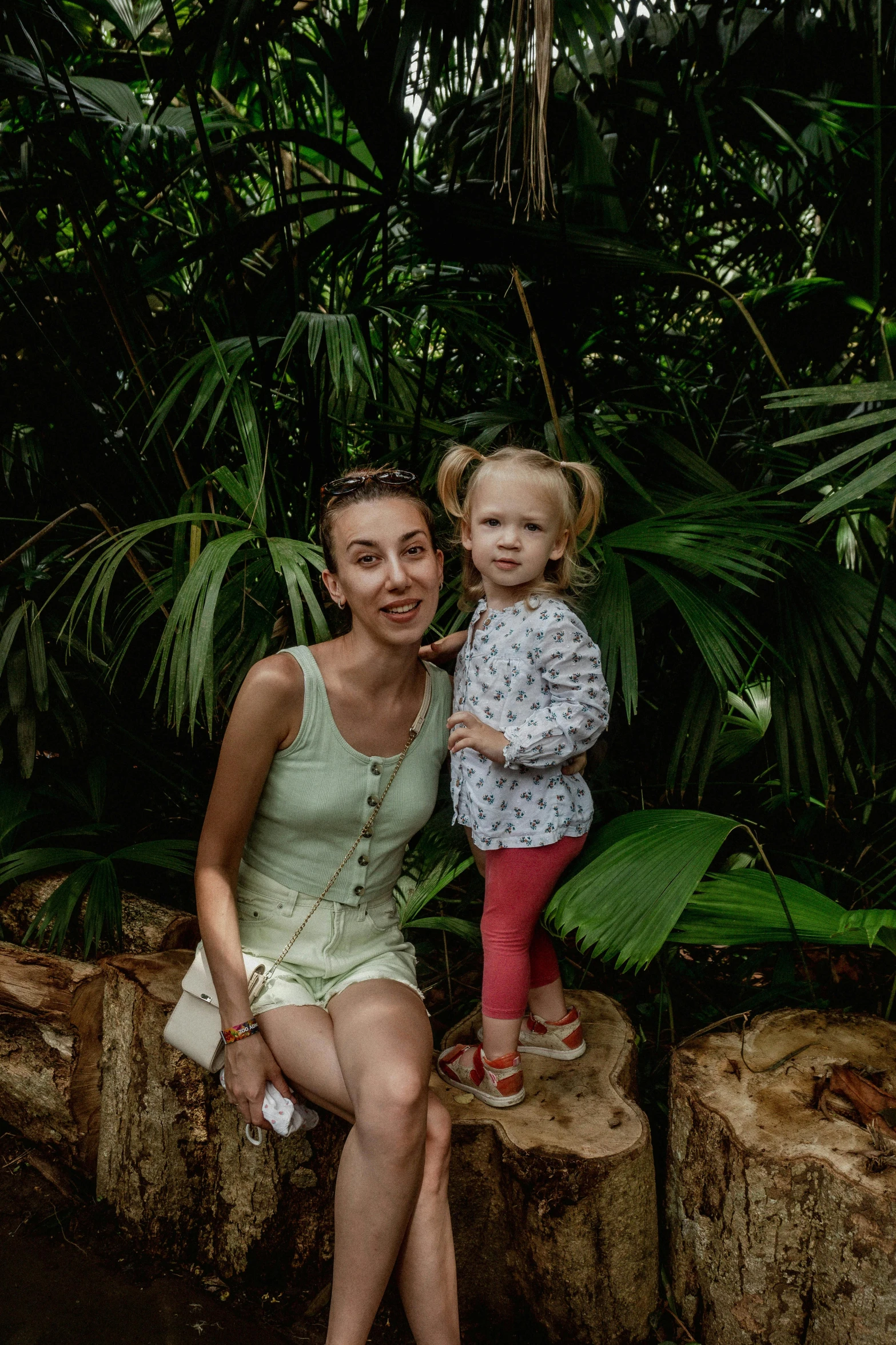 a woman and child are smiling on rocks