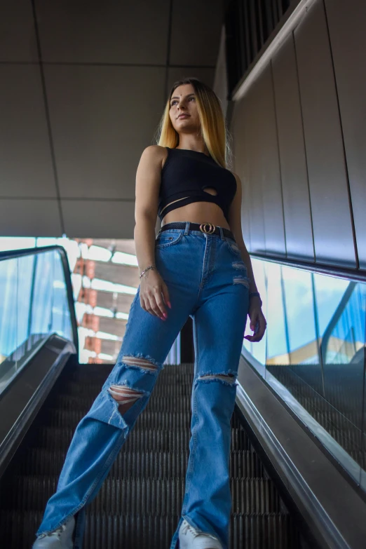 a woman on an escalator with her feet up