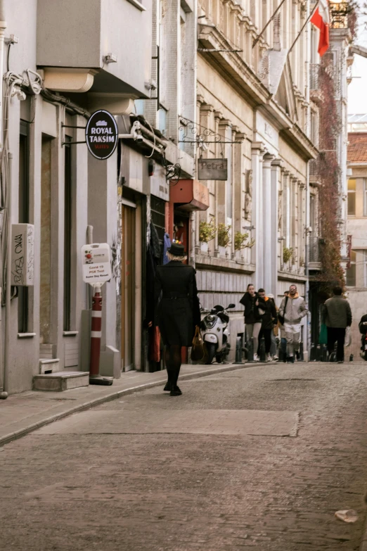 people are walking on the sidewalk near a building