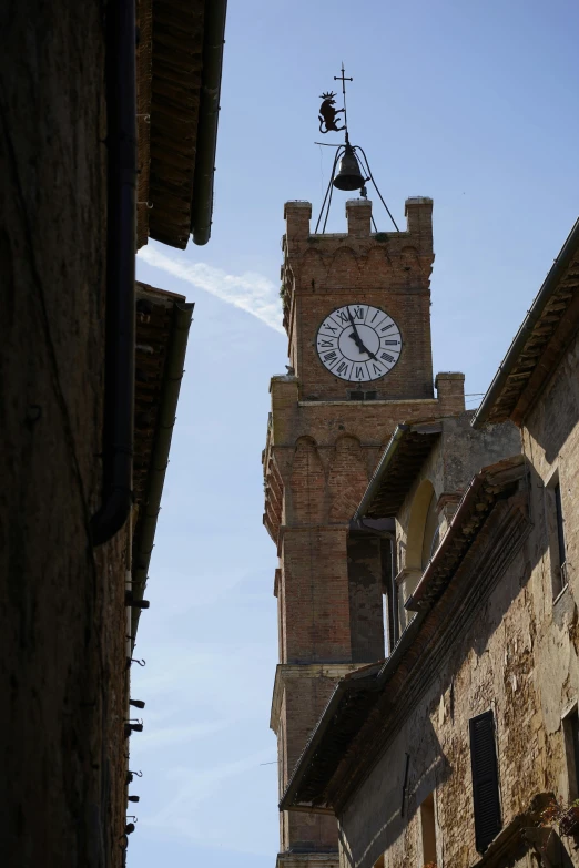 a clock tower towering over the buildings in town