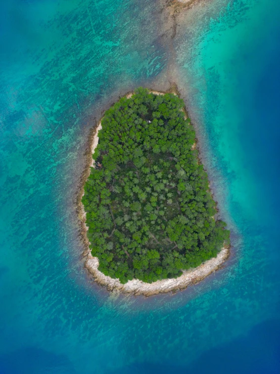 an aerial view of a single island surrounded by water