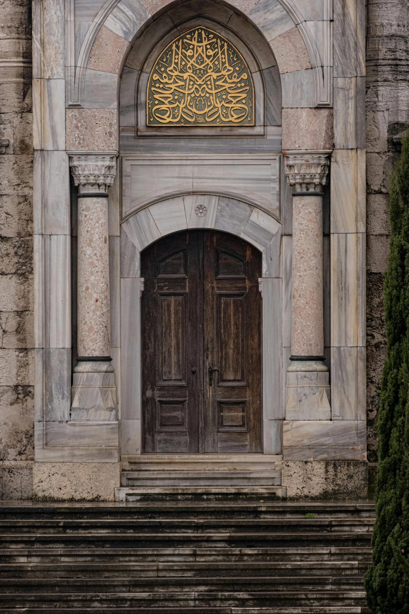 the old stone building has two doors and a doorway