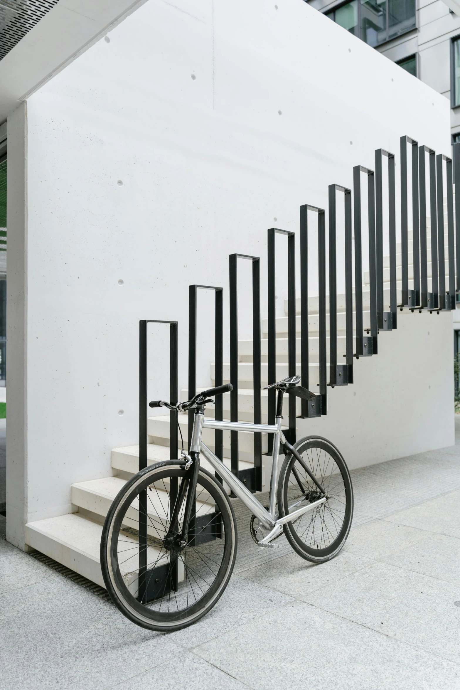 a bike is  to the fence and sits on concrete