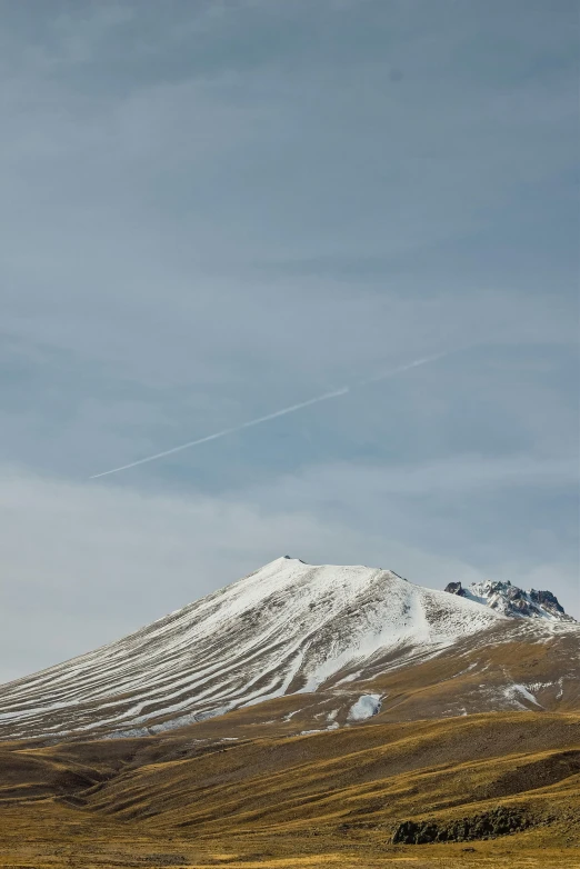 a white mountain covered in snow under a blue sky