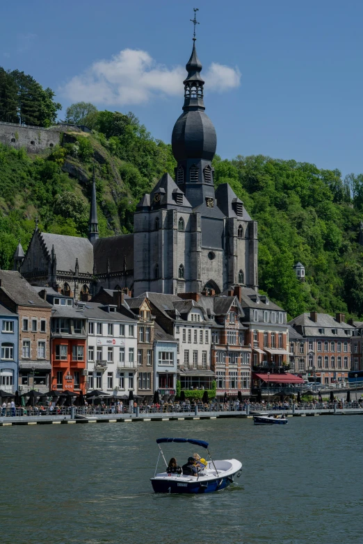 a boat is on the water near a castle like building