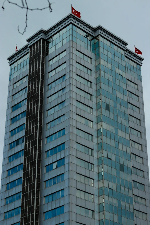 a tall office building against a gray sky