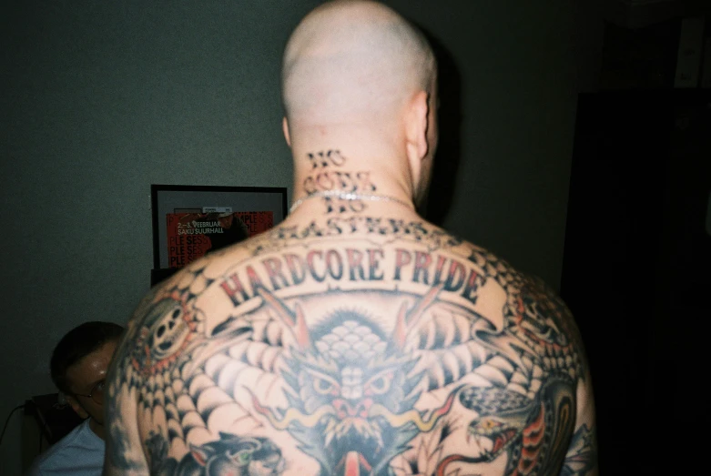 tattooed back man with hard core friday tattoo