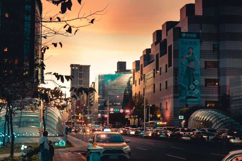 a city street at dusk with a bright yellow sky