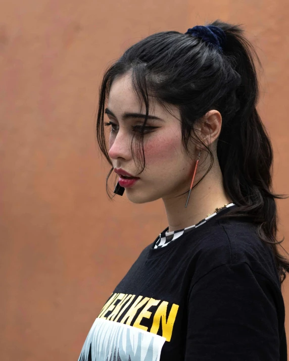 a woman with bangs on her hair and wearing black shirt