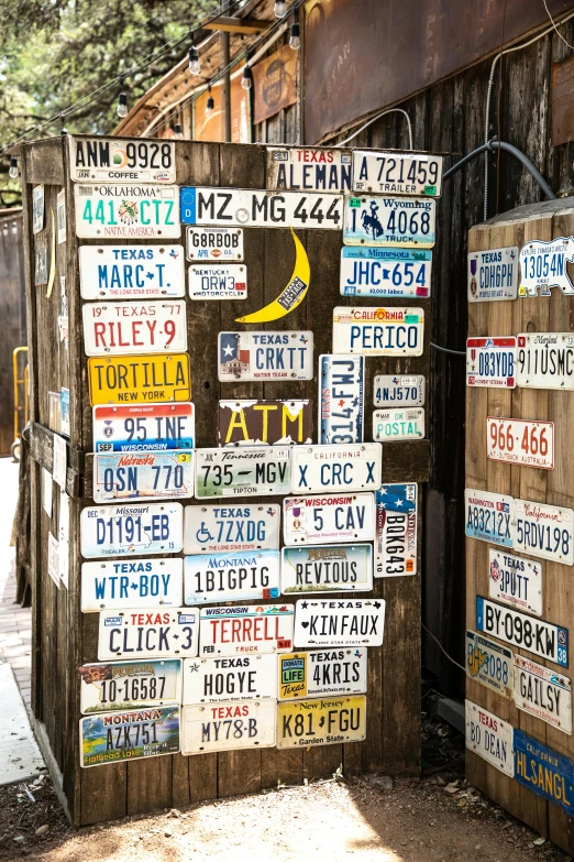 the sign board has many license plates on it