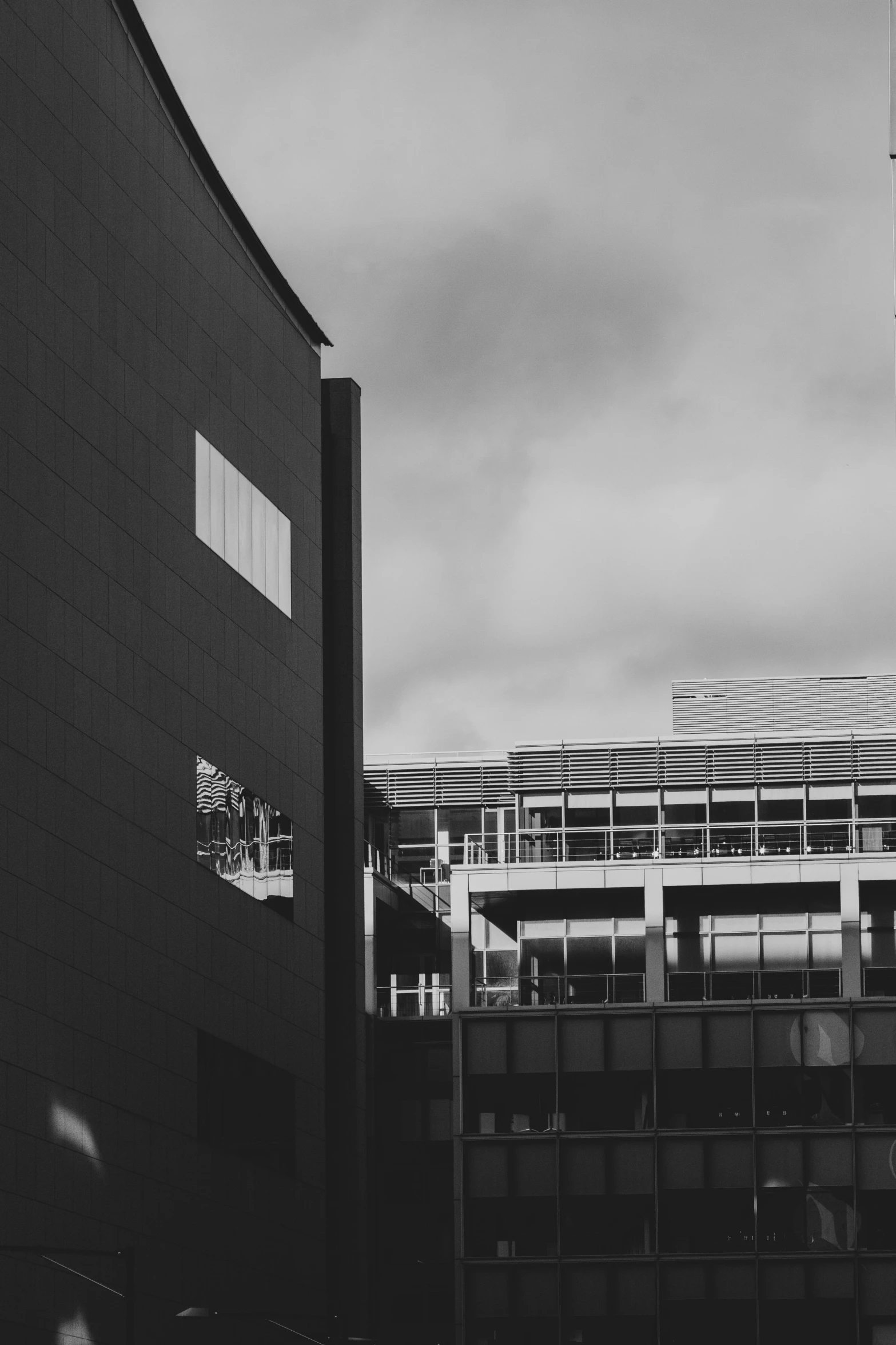 the large building is behind a fence and tall clock tower