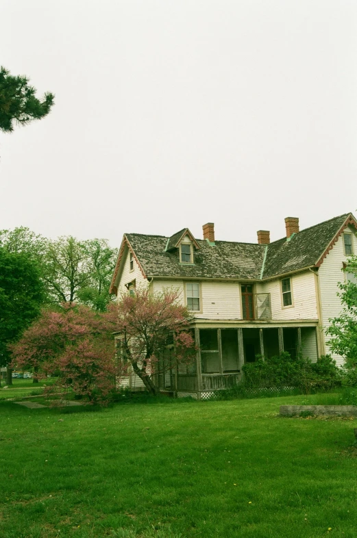 an old run down house with the front yard open