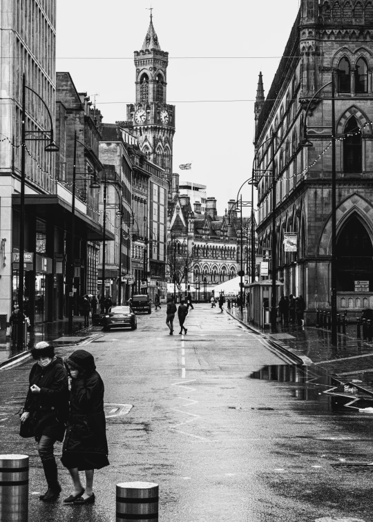 people walking down a street in the rain