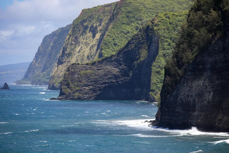 cliffs overlooking the water near an island in hawaii