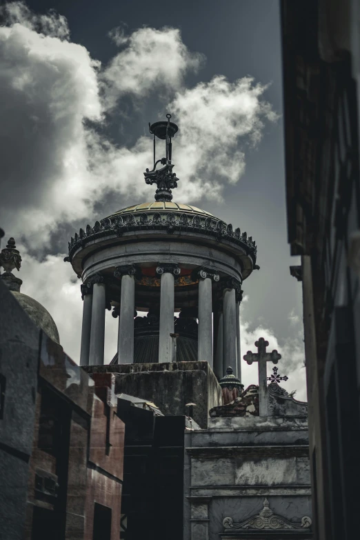 a bell tower that is located below the clouds