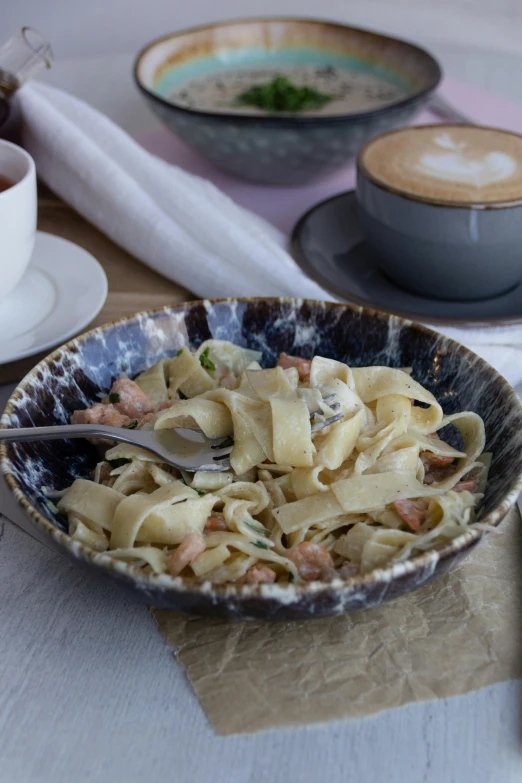 the bowl is full of noodles and meat