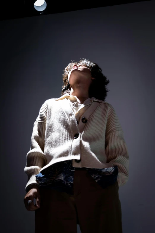 a woman standing on top of a stage in a white shirt and skirt