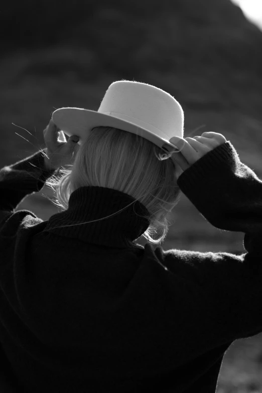 a black and white po of a woman with a hat