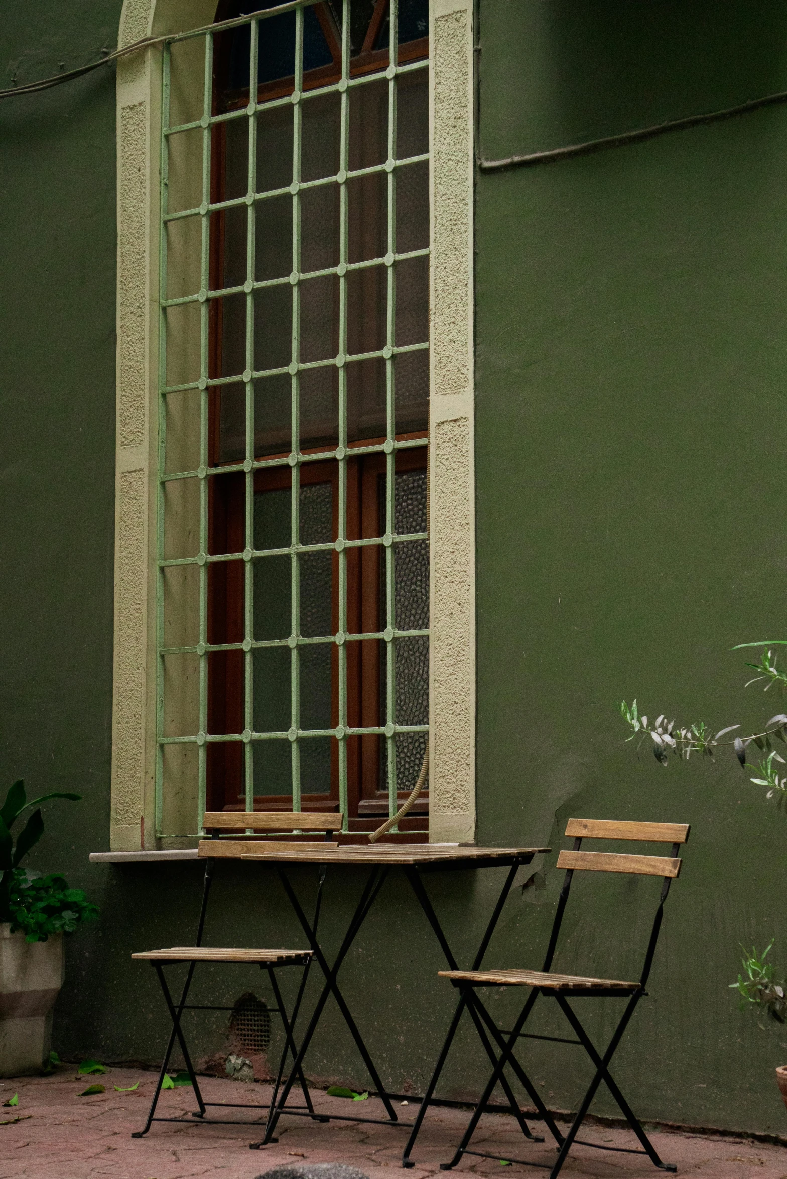 a table with two chairs near by and a window