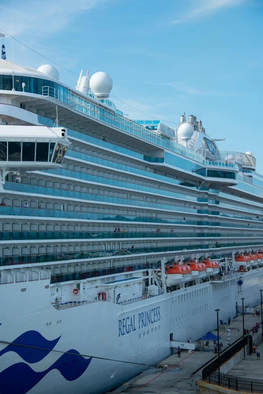 a cruise ship that is docked next to another boat