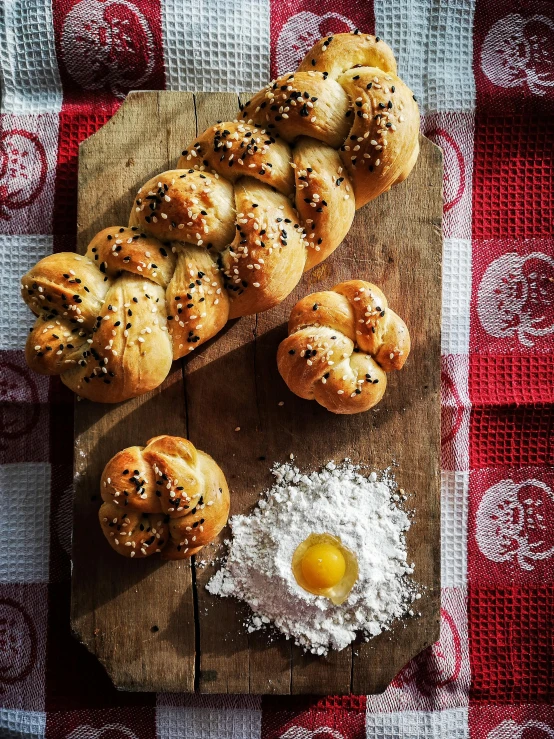 a close up of a bunch of buns and some salt on a board