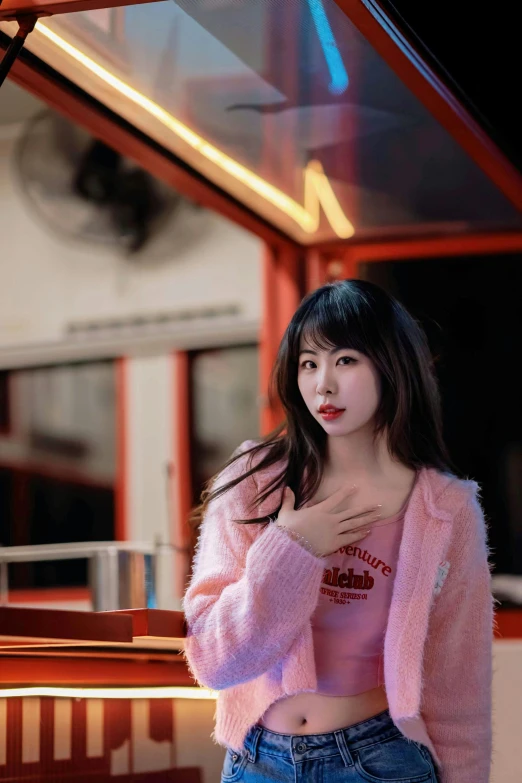 asian woman wearing a pink sweater with a pink cardigan