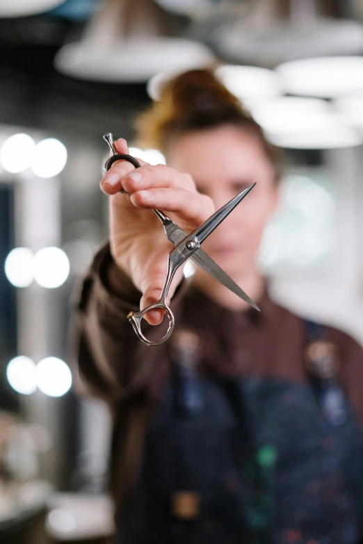 a person holding scissors in front of the camera