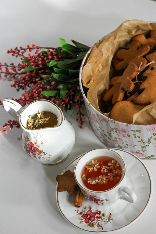 some  cocoa cookies in their containers and tea set