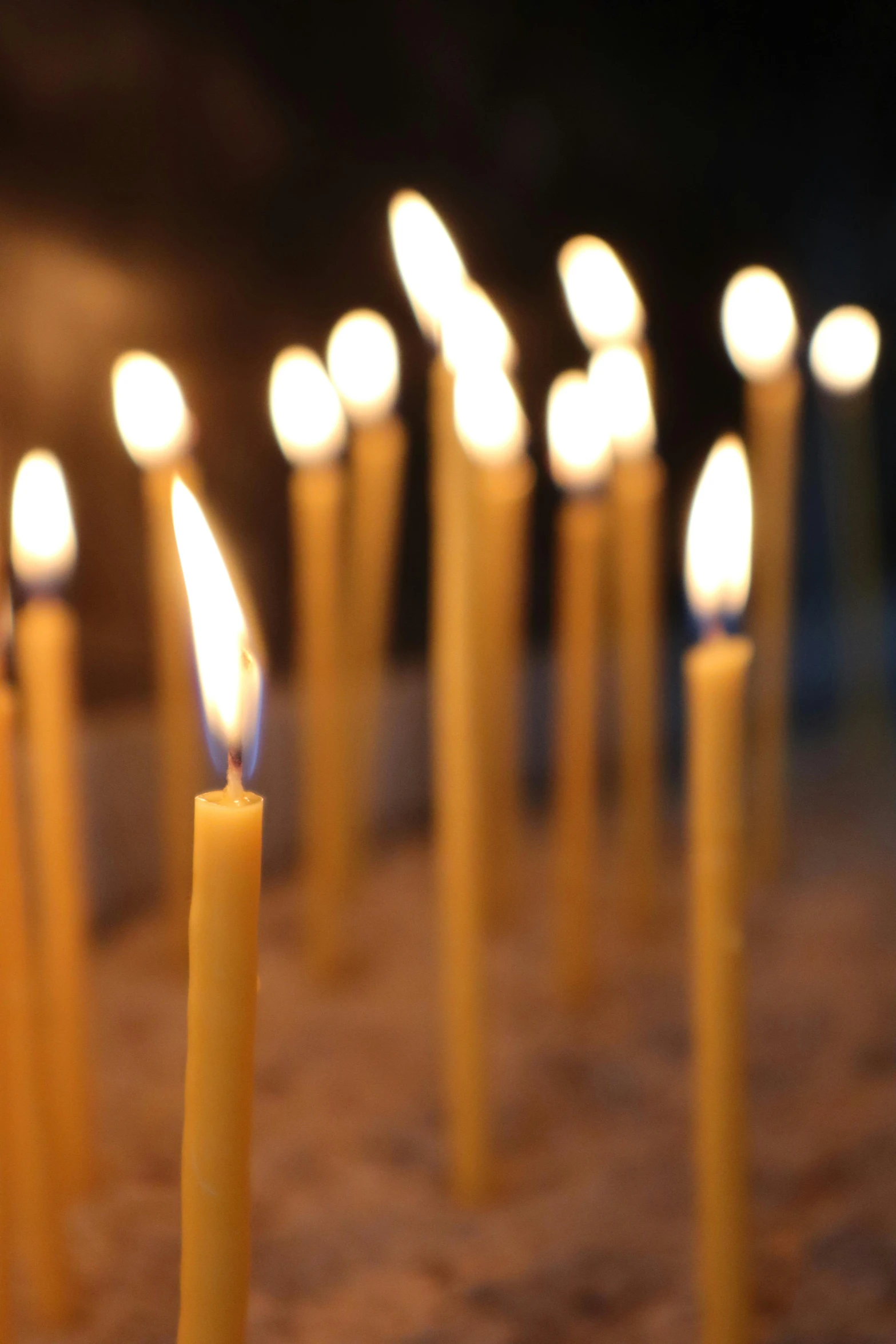 some lit candles in the middle of a table